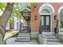 Inviting front entrance with stone steps leading to a double door with arched window above at 543 Fletcher Ave, Indianapolis, IN 46203