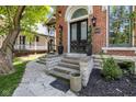Elegant front entry with landscaped steps leading to a black double door with decorative glass at 543 Fletcher Ave, Indianapolis, IN 46203