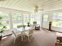Sunroom filled with natural light, comfortable seating, and views of the outdoor greenery at 641 Lawndale Dr, Plainfield, IN 46168