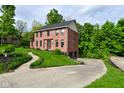 Brick home with green lawn, driveway, and large trees at 6567 Kings Ct, Avon, IN 46123