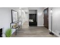 Welcoming foyer features neutral walls, wood-look floors, and convenient coat storage for an organized entry at 8120 E 11Th St, Indianapolis, IN 46219