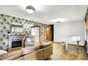 Bright living room with wood floors, a fireplace, and a white piano at 8230 Linda Leigh Ln, Indianapolis, IN 46217