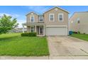 Charming two-story home with a well-maintained lawn and attached two-car garage at 8238 Crackling Ln, Indianapolis, IN 46259