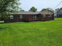 Green backyard view of brick house with a deck perfect for outdoor entertaining at 8510 E Mcgregor Rd, Indianapolis, IN 46259