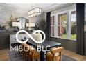 Sophisticated dining room with decorative wall art, a modern chandelier, and a large window providing natural light at 9602 Fall Creek Rd, Indianapolis, IN 46256