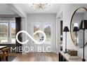 Welcoming foyer with a stylish console table, a statement mirror, and double doors offering an elegant entrance at 9602 Fall Creek Rd, Indianapolis, IN 46256