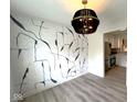 Modern dining room with unique light fixture and stylish wall art, adjacent to the kitchen at 9655 Cedar Cove Ln, Indianapolis, IN 46250