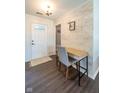 Welcoming entryway with stylish wood-look accent wall and modern desk space at 1084 Lake W Dr, Brownsburg, IN 46112