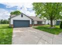 Well-maintained home with a spacious driveway leading to an attached garage at 1084 Lake W Dr, Brownsburg, IN 46112