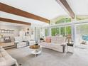 Spacious living room with large windows, plush seating, and open layout is ideal for entertaining at 12 Windridge St, Country Club Heights, IN 46011