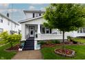 Attractive two-story house featuring a welcoming front porch and well-maintained yard at 1207 Chestnut St, Columbus, IN 47201