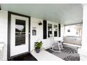 Relaxing front porch with seating, a rocking chair, and charming decor at 1207 Chestnut St, Columbus, IN 47201