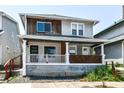 Charming two-story home featuring a cozy front porch with stylish design elements at 1212 S Senate Ave, Indianapolis, IN 46225