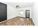 Bright living room with modern ceiling fan, laminate flooring, and lots of natural light at 1212 S Senate Ave, Indianapolis, IN 46225