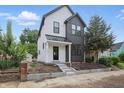Charming two-story home features a landscaped yard and a classic black and white exterior design at 1231 Marlowe Ave, Indianapolis, IN 46202