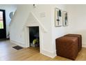 Charming under-stairs nook with a playful pet den, complemented by stylish ottomans and modern wall art at 1231 Marlowe Ave, Indianapolis, IN 46202
