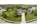 Picturesque aerial view of a home with a well-manicured lawn in a suburban neighborhood at 14130 Autumn Woods Dr, Carmel, IN 46074