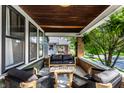 Inviting front porch featuring cozy seating and stylish decor with a wood plank ceiling at 1426 N Euclid Ave, Indianapolis, IN 46201