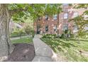 Beautiful brick home with well-maintained lawn and mature shade trees at 1540 N College Ave, Indianapolis, IN 46202