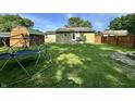 Fenced backyard features a storage shed, mature trees, and an activity center at 1570 S Harriet St, Martinsville, IN 46151
