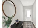 Welcoming entryway featuring a modern mirror, stylish console table, and a decorative rug leading to the front door at 15717 Hush Hickory, Westfield, IN 46074