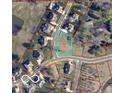 Aerial view of a residential lot surrounded by houses and tree coverage in a suburban neighborhood at 1713 Deer Creek Way, Columbus, IN 47201