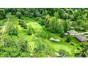 Scenic aerial view of a lush green golf course surrounded by mature trees at 1860 Red Fox E Ct, Martinsville, IN 46151