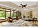Bright living room featuring large windows, hardwood floors, and modern ceiling fan at 1860 Red Fox E Ct, Martinsville, IN 46151
