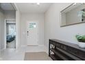 Bright entryway with neutral walls, a console table, a gold mirror, and tile flooring at 18630 Goldwater Rd, Westfield, IN 46062