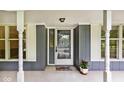 Welcoming front door with sidelights, columns, and a charming flower pot, framed by bright, sunlit windows at 19446 Ethan Allen Ln, Westfield, IN 46074