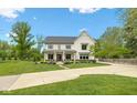 Beautiful two-story home with green lawn and concrete driveway on a sunny day at 20400 Chatham Hills Blvd, Westfield, IN 46074