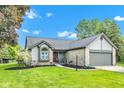Charming home featuring a well-maintained lawn, stone accents, and an attached two-car garage at 206 Cranberry Dr, Greenfield, IN 46140