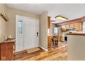 Open foyer with hardwood floors and views into the kitchen with stainless steel appliances at 206 Cranberry Dr, Greenfield, IN 46140
