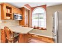 Bright kitchen with stainless steel appliances, eat-in countertop, and large arched window at 206 Cranberry Dr, Greenfield, IN 46140