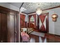 Elegant home foyer with detailed woodwork, a vintage clock, and a cozy, classic aesthetic at 2134 N Alabama St, Indianapolis, IN 46202