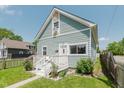 Charming two-story home with light blue siding, white trim, and a cozy front porch at 2230 Pleasant St, Indianapolis, IN 46203