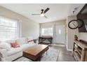 Bright living room with a white sofa, wood floors, ceiling fan, and natural light at 2230 Pleasant St, Indianapolis, IN 46203