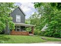 Charming two-story home featuring a welcoming front porch with a porch swing, landscaped yard, and classic architectural details at 31 N Bolton Ave, Indianapolis, IN 46219
