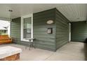 Inviting front porch showcasing a classic porch swing, with views of the neighborhood and a place to relax at 31 N Bolton Ave, Indianapolis, IN 46219