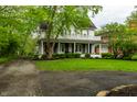 Beautiful two-story home with a large front porch and manicured lawn at 4130 N Meridian St, Indianapolis, IN 46208