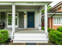 Welcoming front entrance with a charming blue door, complemented by manicured landscaping at 4130 N Meridian St, Indianapolis, IN 46208