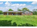 Brick ranch home featuring an attached two-car garage, a large yard, and a paved driveway at 4197 E 250 S, Franklin, IN 46131