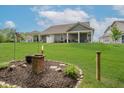 Expansive backyard with lush lawn, featuring a mulched fire pit area, perfect for outdoor entertaining and relaxation at 5020 Eldon Dr, Noblesville, IN 46062