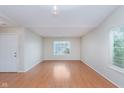 Bright, empty living room with hardwood floors and natural light streaming through the window at 5083 Emmert Dr, Indianapolis, IN 46221