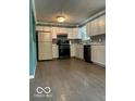 Efficient kitchen featuring white cabinetry and modern black appliances at 5802 Bertha St, Indianapolis, IN 46241