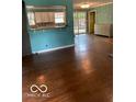The living room features hardwood floors and a kitchen view at 5802 Bertha St, Indianapolis, IN 46241