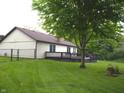 Exterior view of home with expansive backyard, deck, mature tree, and partial fence at 60 Bittersweet Ct, Noblesville, IN 46062
