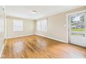 Bright living room with hardwood floors, neutral walls, and ample natural light from multiple windows at 602 W 34Th St, Anderson, IN 46013