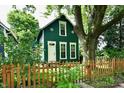 Charming two-story home with a lovely front yard and a mature tree providing shade at 631 Prospect St, Indianapolis, IN 46203