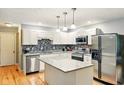 Well-lit kitchen with white cabinets, stainless steel appliances, and granite countertops at 6462 Wings Ct, Brownsburg, IN 46112